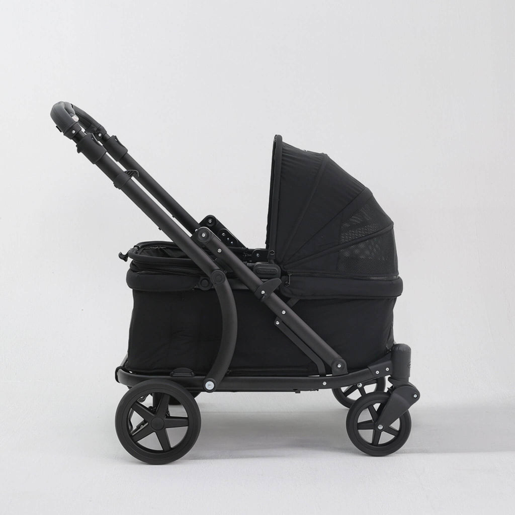 A black pet stroller with a matching canopy and four wheels, shown from a side profile against a light gray studio background.